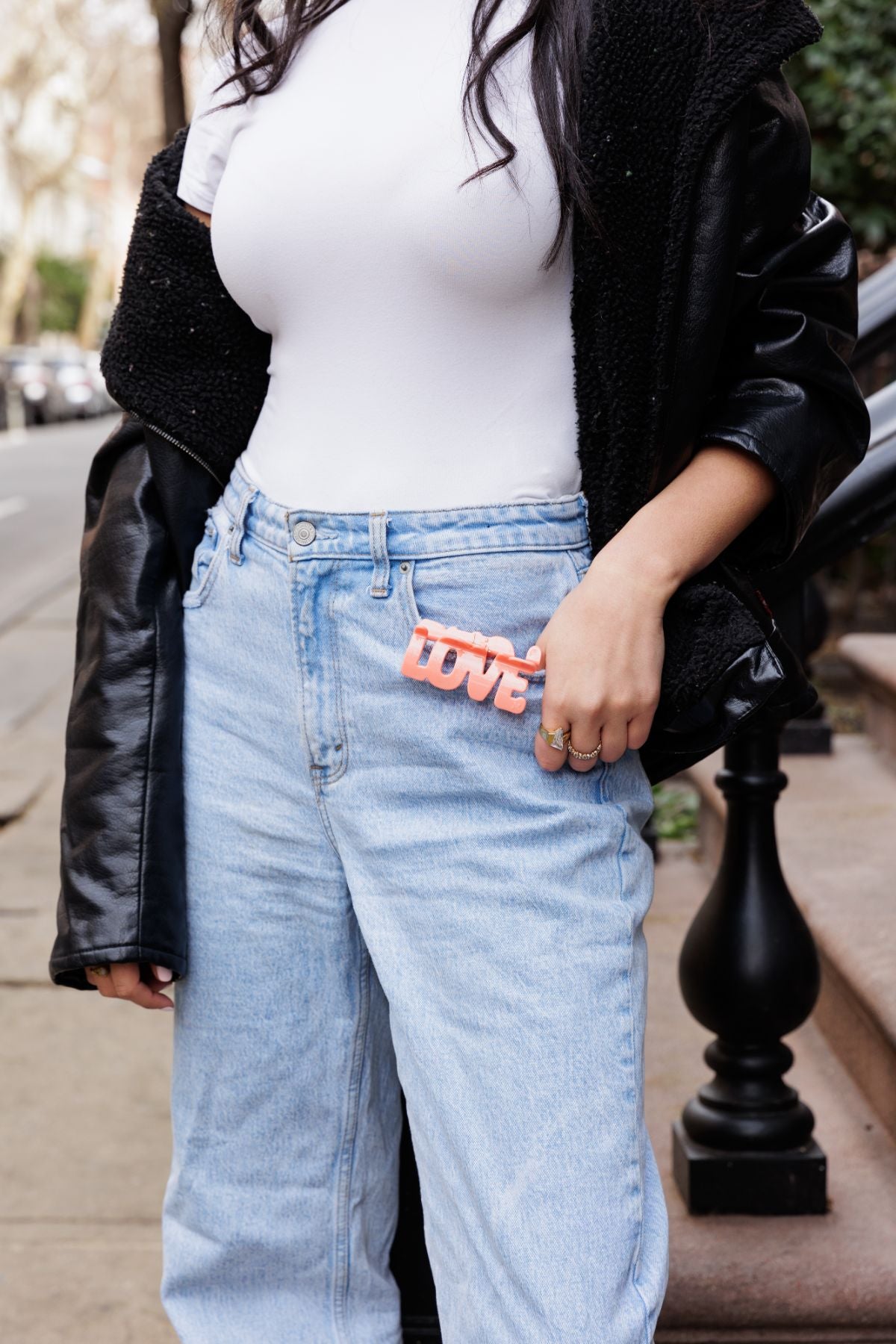 Girl with white shirt and blue jeans posing in NYC with a patented LOVE hair claw by FiZZY