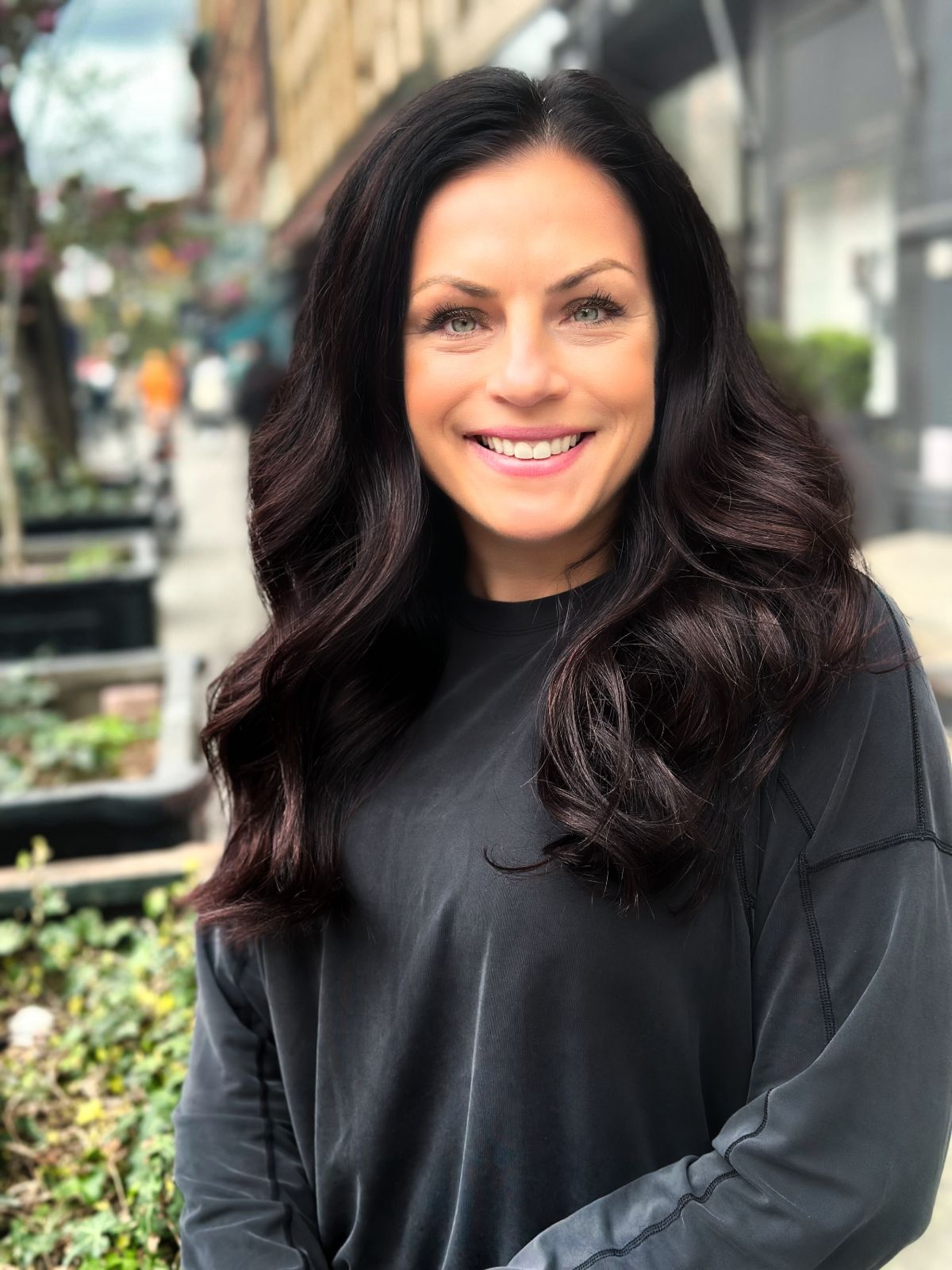 Woman founder of FiZZY, a brand offering patented hair claws for women, posing in NYC