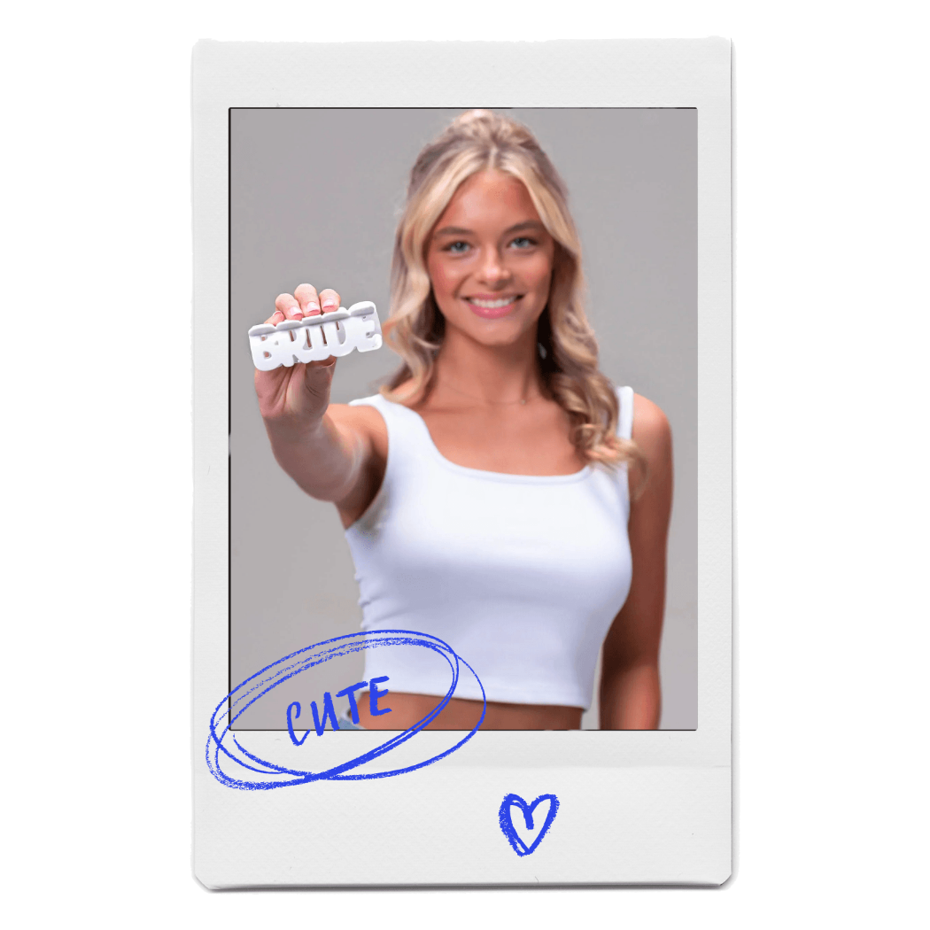 Young blonde woman holding a BRIDE word claw clip by FiZZY