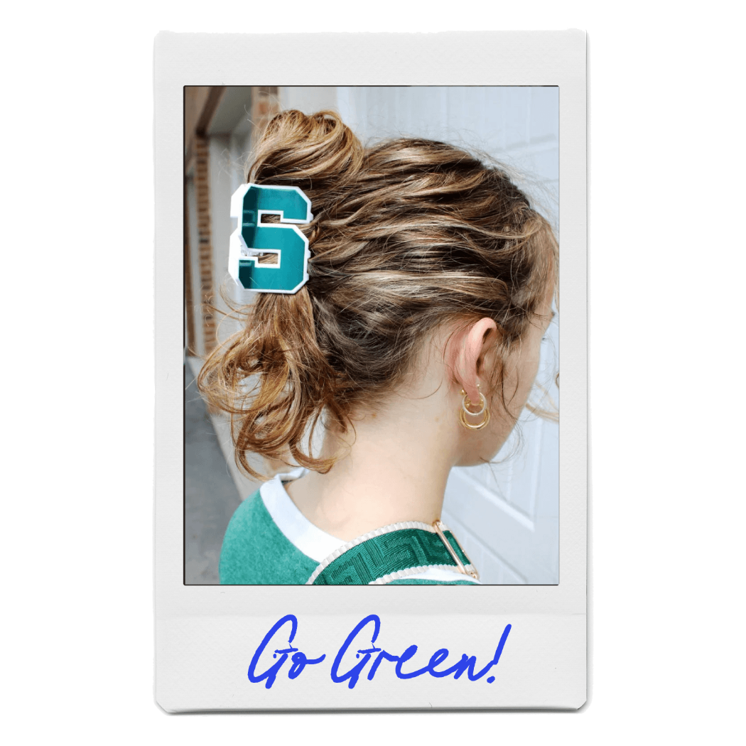 Young blonde woman wearing a collegiate claw clip by FiZZY repping the Michigan State "S" logo